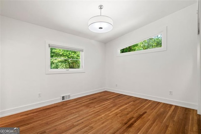 1492 Sagewood Cir, Stone Mountain, GA 30083 - empty room featuring plenty of natural light and wood finished floors