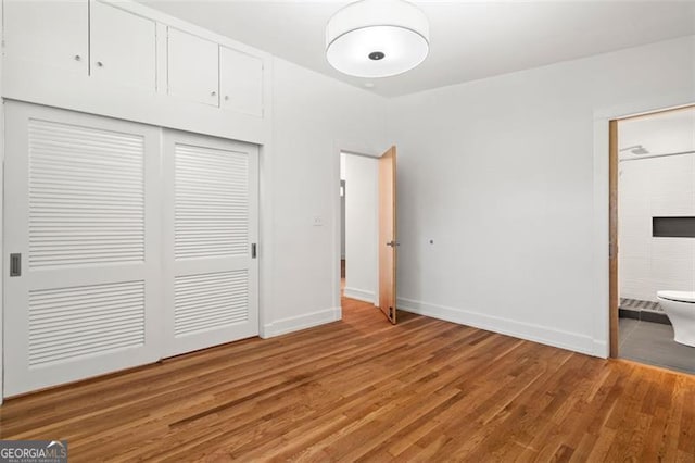 1492 Sagewood Cir, Stone Mountain, GA 30083 - unfurnished bedroom featuring a closet, light wood-style flooring, and ensuite bath