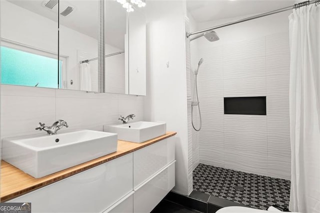 1492 Sagewood Cir, Stone Mountain, GA 30083 - full bathroom featuring double vanity, a tile shower, and backsplash