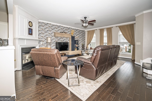 3343 Lathenview Ct, Milton, GA 30004 - living room with a fireplace with flush hearth, ceiling fan, dark wood-style floors, crown molding, and brick wall