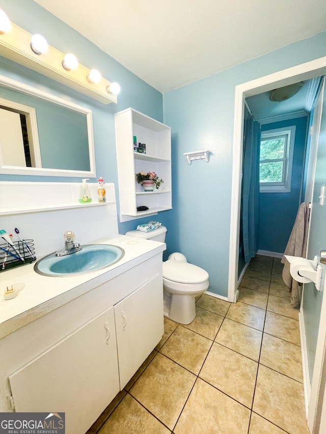 1191 Zoar Rd, Baxley, GA 31513 - bathroom with toilet, vanity, tile patterned flooring, a shower with shower curtain, and baseboards
