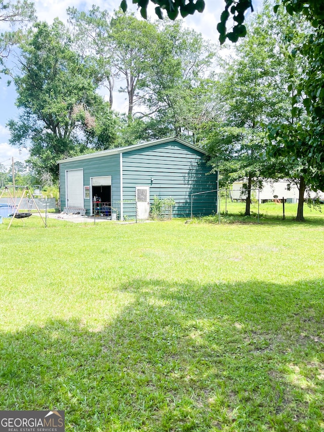 1191 Zoar Rd, Baxley, GA 31513 - view of yard with a detached garage and an outdoor structure