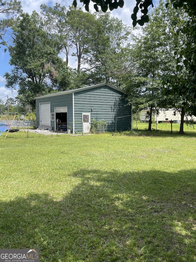 1191 Zoar Rd, Baxley, GA 31513 - view of yard with a detached garage and an outbuilding