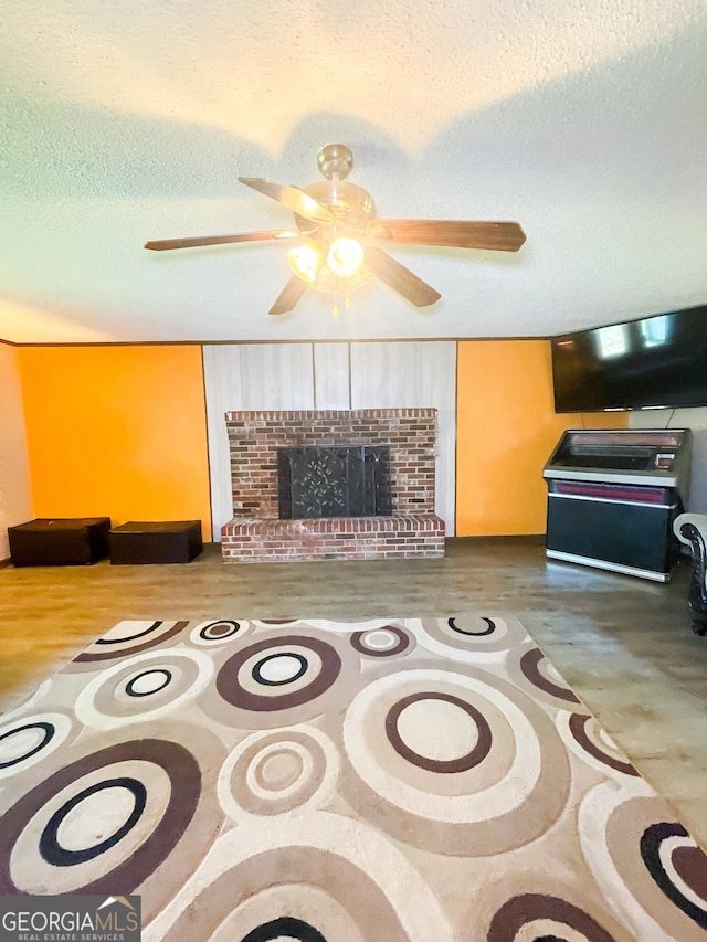 1191 Zoar Rd, Baxley, GA 31513 - living area featuring a ceiling fan, a textured ceiling, and a brick fireplace