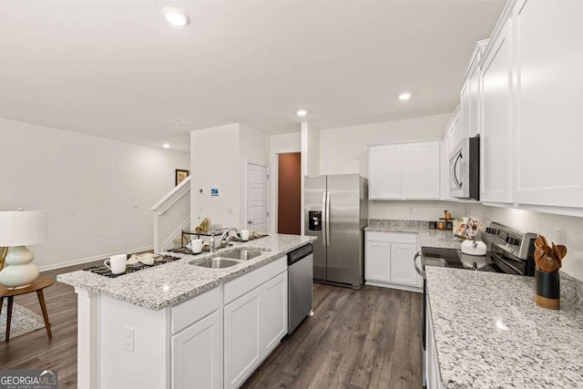 1404 Gray Branch Dr, Lawrenceville, GA 30045 - kitchen featuring appliances with stainless steel finishes, a sink, dark wood-style flooring, a kitchen island with sink, and recessed lighting