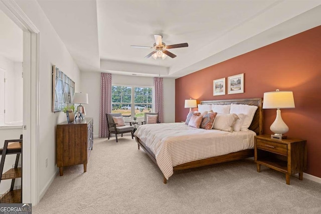1404 Gray Branch Dr, Lawrenceville, GA 30045 - bedroom featuring light carpet, a tray ceiling, baseboards, and ceiling fan