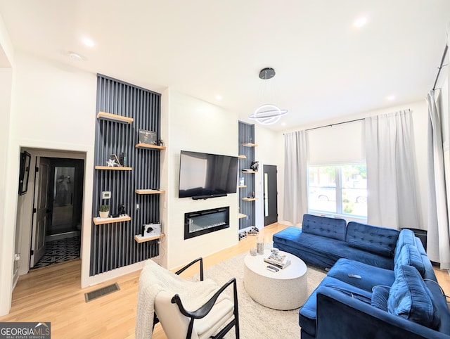 123 Dahlgren St SE, Atlanta, GA 30317 - living area with light wood finished floors, a glass covered fireplace, and recessed lighting