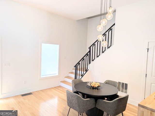 123 Dahlgren St SE, Atlanta, GA 30317 - dining room featuring light wood finished floors, stairway, and baseboards