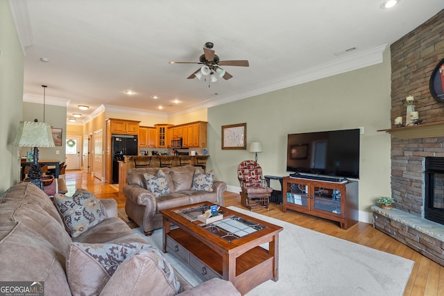 1724 Watercrest Way # G, Young Harris, GA 30582 - living area featuring ceiling fan, a fireplace, light wood-style floors, crown molding, and baseboards