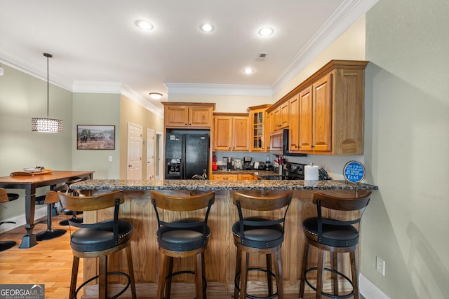 1724 Watercrest Way # G, Young Harris, GA 30582 - kitchen with black fridge with ice dispenser, stainless steel microwave, brown cabinetry, glass insert cabinets, and a peninsula