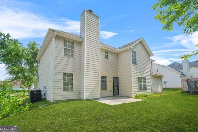 6799 Hill Creek Cv, Lithonia, GA 30058 - back of property with central AC unit, a patio, a chimney, a trampoline, and a yard