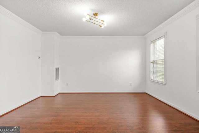 6799 Hill Creek Cv, Lithonia, GA 30058 - unfurnished room featuring a textured ceiling, crown molding, hardwood / wood-style floors, and baseboards