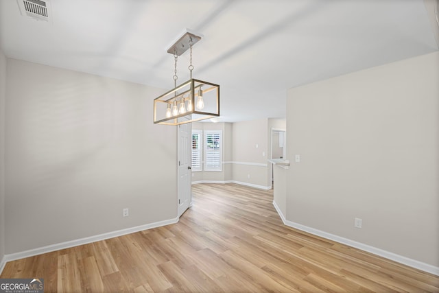 105 Paces Landing Trl, Newnan, GA 30263 - unfurnished dining area featuring light wood-style floors, baseboards, and a chandelier
