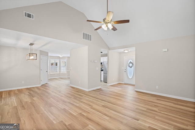 105 Paces Landing Trl, Newnan, GA 30263 - unfurnished living room with ceiling fan, high vaulted ceiling, baseboards, and light wood-type flooring