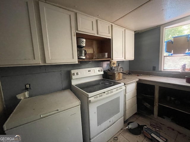 243 Lakeside Trl, Martin, GA 30557 - kitchen with white electric range, light countertops, white cabinets, and light tile patterned flooring