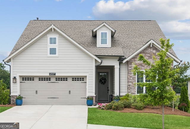 6937 River Rock Dr, Flowery Branch, GA 30542 - view of front facade featuring driveway, roof with shingles, stone siding, a front yard, and an attached garage