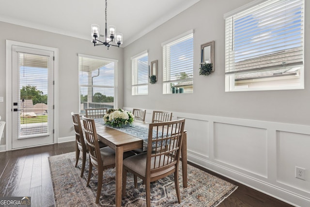 6937 River Rock Dr, Flowery Branch, GA 30542 - dining space with a chandelier, healthy amount of natural light, wainscoting, dark wood-style floors, and a decorative wall