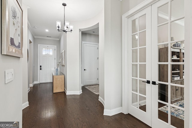 6937 River Rock Dr, Flowery Branch, GA 30542 - entryway featuring a chandelier, dark wood finished floors, crown molding, and french doors