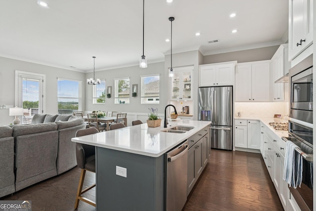 6937 River Rock Dr, Flowery Branch, GA 30542 - kitchen featuring stainless steel appliances, plenty of natural light, open floor plan, crown molding, and decorative backsplash