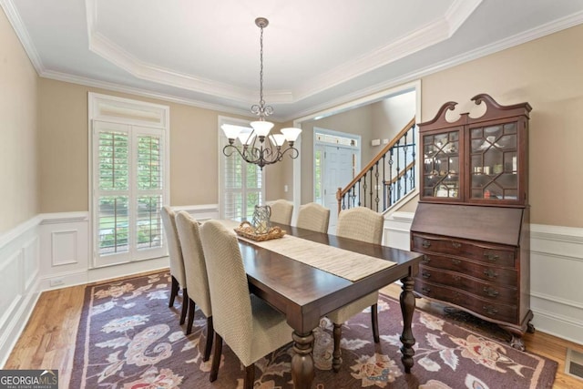 412 Mill Stream Way, Woodstock, GA 30188 - dining area with a chandelier, wood finished floors, a wainscoted wall, stairs, and a tray ceiling