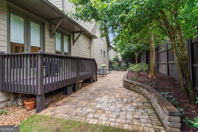 3075 Woodvale Ct, Johns Creek, GA 30022 - fenced backyard with a wooden deck and a patio area