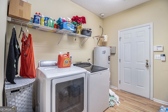 2928 Mandy Ct, Jonesboro, GA 30236 - washroom featuring independent washer and dryer, light wood-style flooring, baseboards, a textured ceiling, and water heater