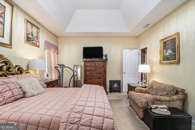 2928 Mandy Ct, Jonesboro, GA 30236 - bedroom with a wood stove, a tray ceiling, and carpet flooring