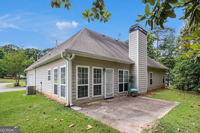 2928 Mandy Ct, Jonesboro, GA 30236 - rear view of property featuring a chimney, a yard, a shingled roof, a patio, and central AC