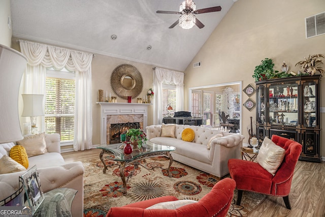 2928 Mandy Ct, Jonesboro, GA 30236 - living room featuring wood finished floors, ceiling fan, healthy amount of natural light, and high vaulted ceiling
