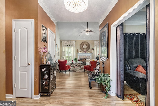 2928 Mandy Ct, Jonesboro, GA 30236 - hall with light wood-style flooring, a chandelier, ornamental molding, a textured ceiling, and baseboards