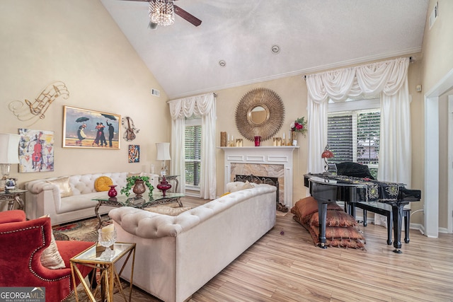 2928 Mandy Ct, Jonesboro, GA 30236 - living area featuring a ceiling fan, wood finished floors, a high end fireplace, and high vaulted ceiling