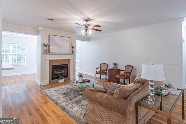370 Grand Teton Cir, Fayetteville, GA 30215 - living area featuring ornamental molding, a ceiling fan, wood finished floors, a tile fireplace, and baseboards