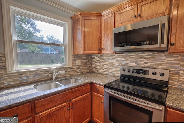 1177 Castle Way, Norcross, GA 30093 - kitchen featuring stainless steel appliances, a sink, tasteful backsplash, brown cabinets, and dark stone countertops