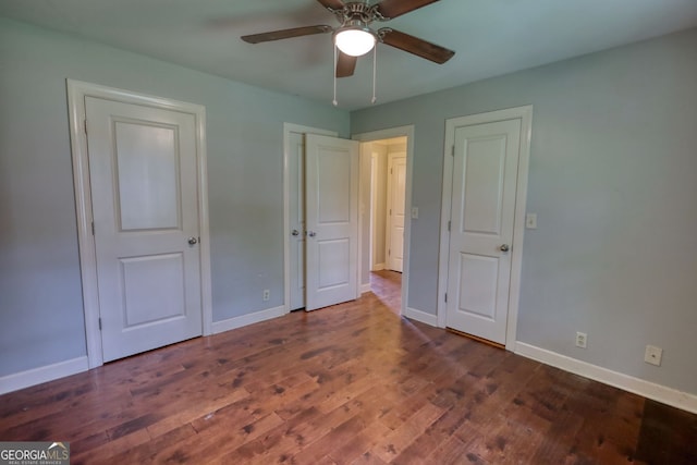 1177 Castle Way, Norcross, GA 30093 - unfurnished bedroom with baseboards, wood finished floors, and ceiling fan
