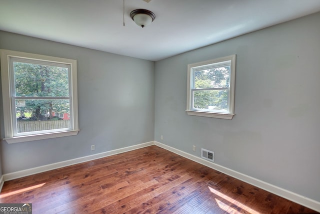 1177 Castle Way, Norcross, GA 30093 - spare room featuring healthy amount of natural light, baseboards, and wood-type flooring