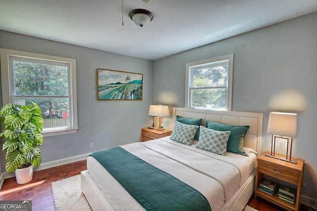 1177 Castle Way, Norcross, GA 30093 - bedroom featuring multiple windows, baseboards, and wood finished floors