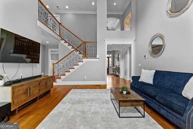 55 Jolie Ln, Sharpsburg, GA 30277 - living area with a towering ceiling, wood finished floors, stairway, ornamental molding, and recessed lighting