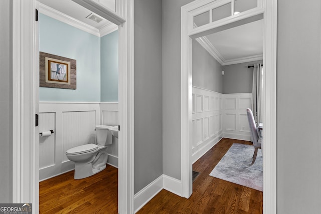 55 Jolie Ln, Sharpsburg, GA 30277 - bathroom featuring ornamental molding, a decorative wall, wainscoting, and wood finished floors
