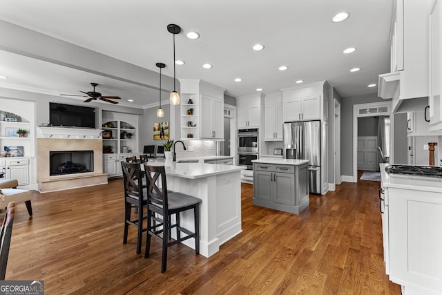 55 Jolie Ln, Sharpsburg, GA 30277 - kitchen featuring open shelves, stainless steel appliances, ceiling fan, light countertops, and a peninsula