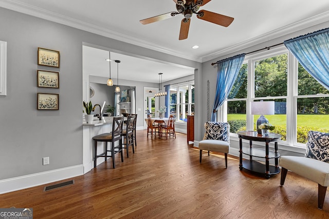 55 Jolie Ln, Sharpsburg, GA 30277 - living area with plenty of natural light, ceiling fan, dark wood finished floors, crown molding, and recessed lighting