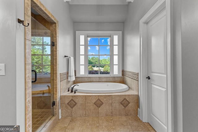 55 Jolie Ln, Sharpsburg, GA 30277 - bathroom with a bath, a stall shower, and healthy amount of natural light