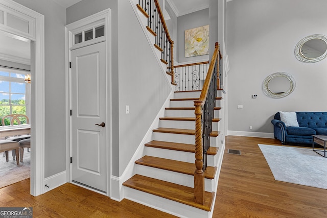 55 Jolie Ln, Sharpsburg, GA 30277 - stairway featuring wood finished floors and ornamental molding