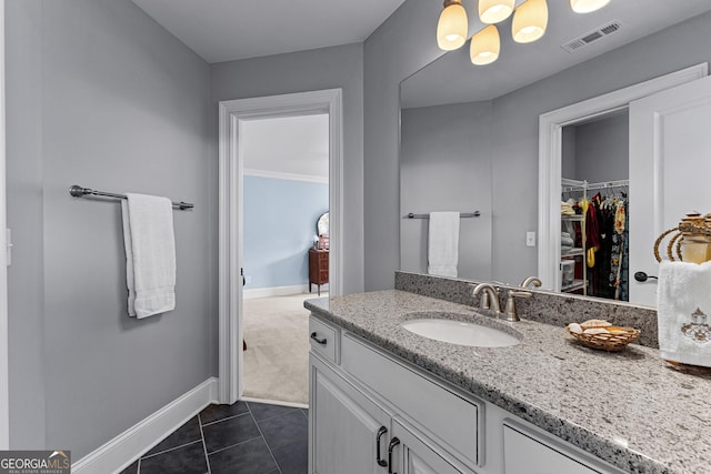 55 Jolie Ln, Sharpsburg, GA 30277 - bathroom with vanity, a spacious closet, and tile patterned flooring