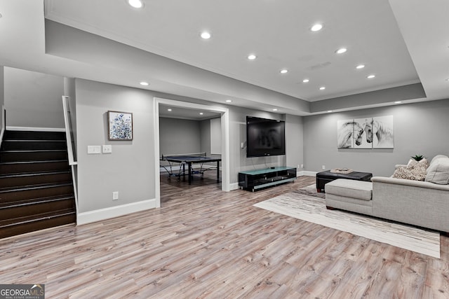 55 Jolie Ln, Sharpsburg, GA 30277 - living room with light wood finished floors, a tray ceiling, stairs, recessed lighting, and crown molding