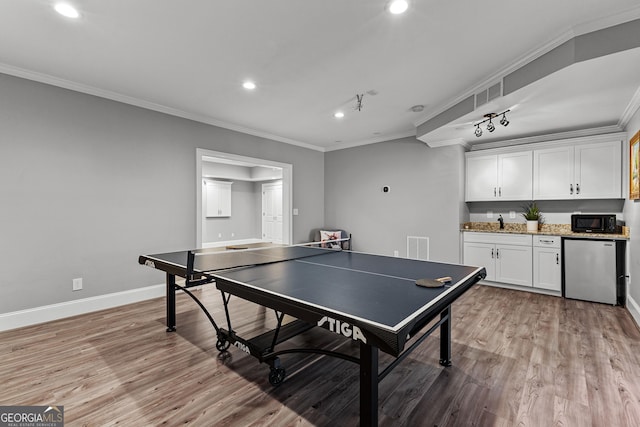 55 Jolie Ln, Sharpsburg, GA 30277 - playroom with crown molding, recessed lighting, light wood-style floors, and bar