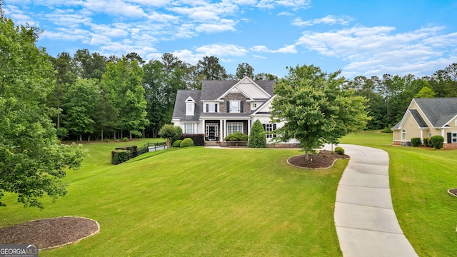 55 Jolie Ln, Sharpsburg, GA 30277 - view of front of home with a front lawn, driveway, and view of scattered trees