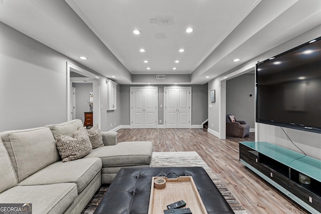 55 Jolie Ln, Sharpsburg, GA 30277 - living area featuring light wood finished floors, a raised ceiling, recessed lighting, and crown molding