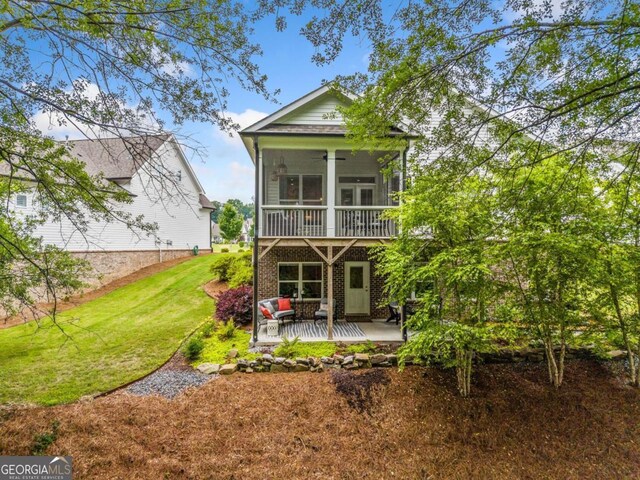309 Mcdaniel Pl, Canton, GA 30115 - rear view of property with a ceiling fan, a yard, a sunroom, and a patio area