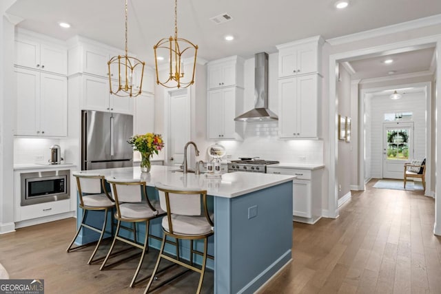 309 Mcdaniel Pl, Canton, GA 30115 - kitchen with wall chimney exhaust hood, appliances with stainless steel finishes, backsplash, white cabinets, and recessed lighting