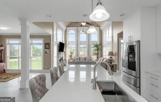 413 Canterbury Way, Jonesboro, GA 30236 - kitchen featuring stainless steel fridge with ice dispenser, open floor plan, white cabinetry, light countertops, and pendant lighting